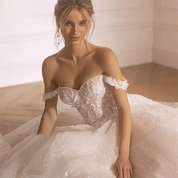 Robes de mariée épaules dénudées en organza avec broderies et sequins