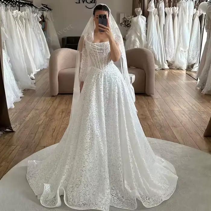 Robe de mariée élégante en dentelle brodée sur filet, ligne a, longueur au sol, sans manches, col ca